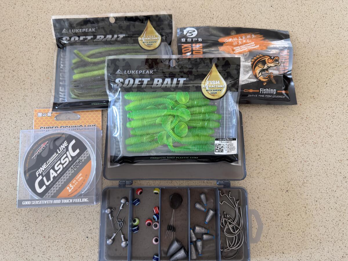 B001 kit contents spread - tackle box and soft plastics